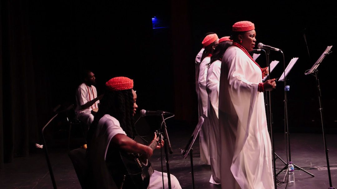 Guitarist and ensemble on stage in performance
