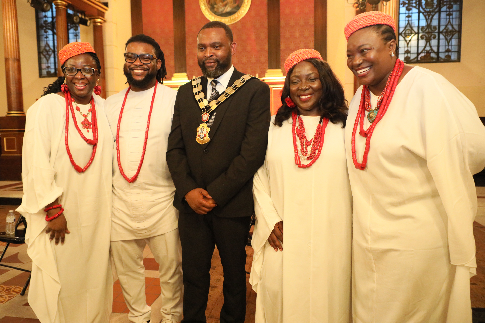 Cast in white robes and coral regalia with the Mayor